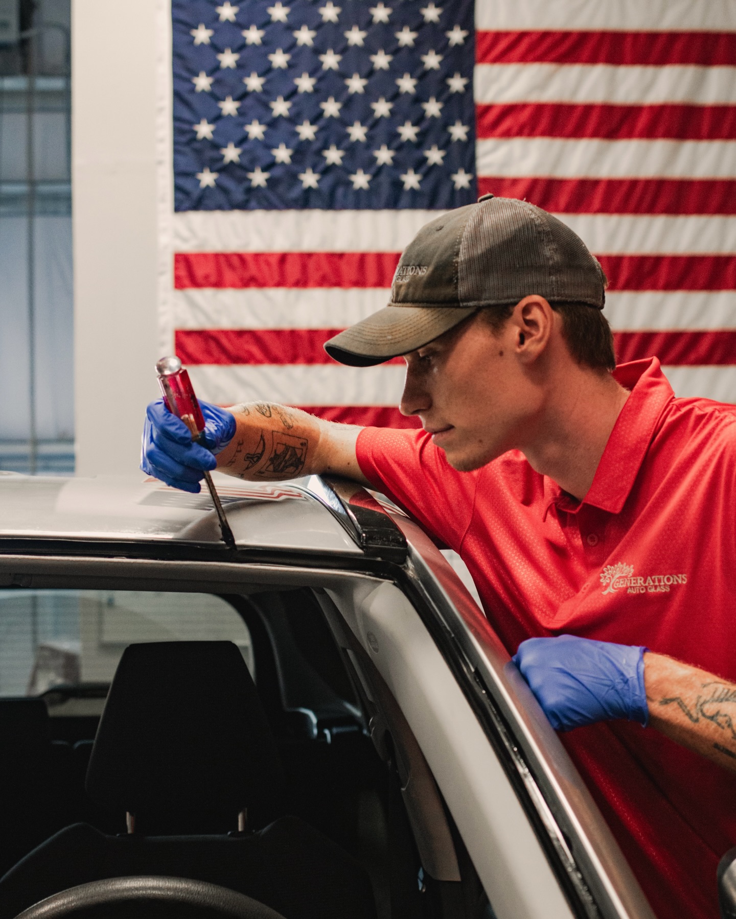 Generations Auto Glass technician applying windshield primer in Little Rock AR shop